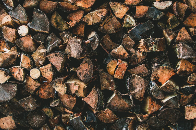 Chopped rounds of firewood and offcut timber stacked in a heap