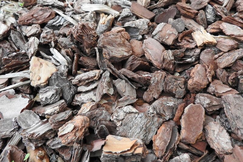 A close-up heap of shredded wood chips and bark mulch from green waste processing